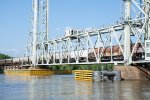 Closer shot of grain hoppers rolling across the Neches River Lift Bridge